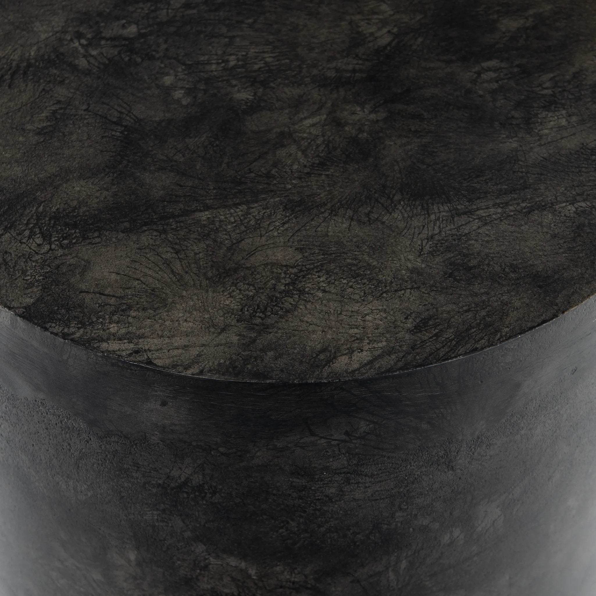 Made from raw black-finished iron, a chunky end table inspired by Brutalist-era shaping brings an industrial vibe to any room Amethyst Home provides interior design, new home construction design consulting, vintage area rugs, and lighting in the Los Angeles metro area.