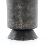 Made from raw black-finished iron, a chunky end table inspired by Brutalist-era shaping brings an industrial vibe to any room Amethyst Home provides interior design, new home construction design consulting, vintage area rugs, and lighting in the Miami metro area.