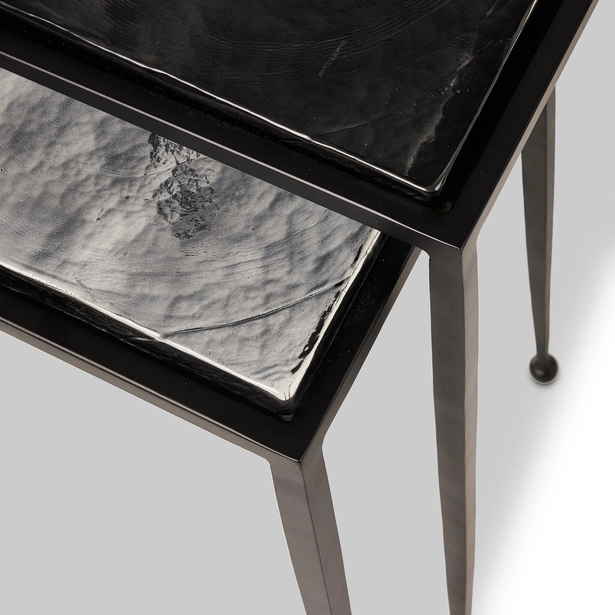 Slim, airy bases of black-finished iron support two varied-height nesting tables of smoked black glass. Designed to bunch or pull apart as desired, with ease Amethyst Home provides interior design, new home construction design consulting, vintage area rugs, and lighting in the Nashville metro area.