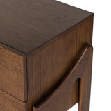 Made from brown-finished ash with leather-wrapped hardware, wide scale and sculptural details reflect the Brazilian midcentury inspiration behind this dual-drawer nightstand Amethyst Home provides interior design, new home construction design consulting, vintage area rugs, and lighting in the Los Angeles metro area.