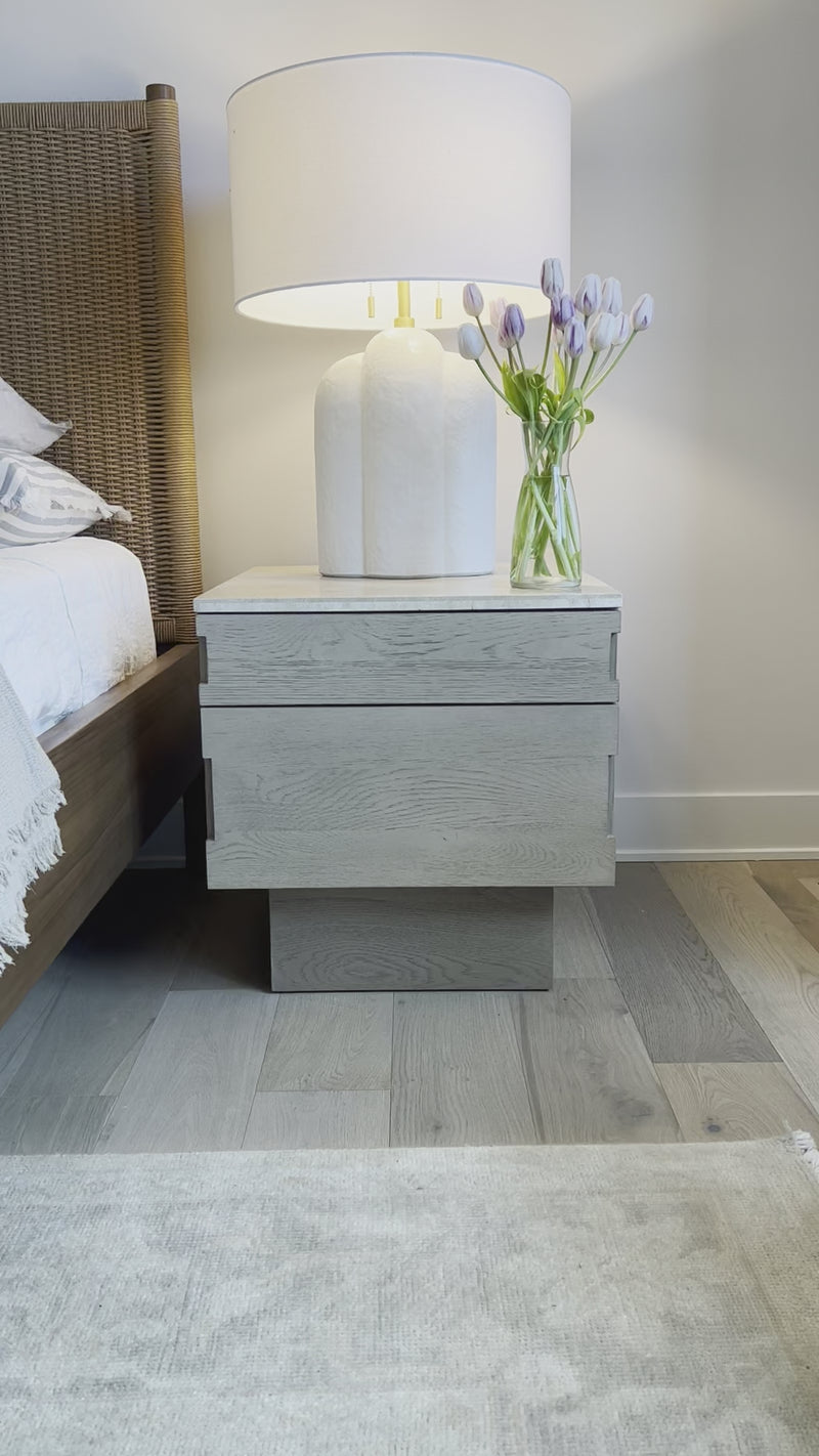 Warm travertine is the highlight of this modern nightstand.  The Lennon nightstand is wonderful as it has a smaller footprint yet great storage. Amethyst Home provides interior design, new home construction design consulting, vintage area rugs, and lighting in the Newport Beach metro area.