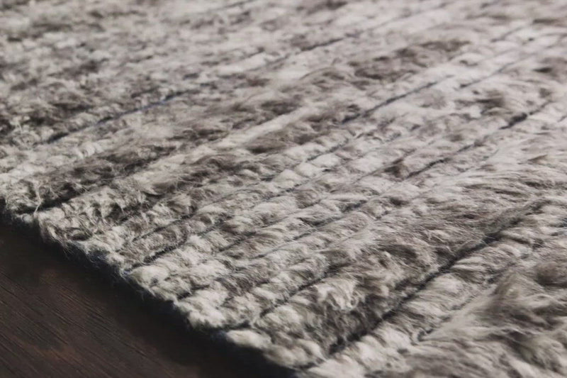 A nod to timeless Moroccan style, the Khalid Pewter/Ink Area rug is hand-knotted in India by skilled artisans. The soft pile features 100% natural, undyed wool, lending slight variations in tones that make each piece it's own. Plus, each rug is finished with a thoughtfully designed fringe.  Hand-Knotted 100% Wool KF-04 Pewter/Ink