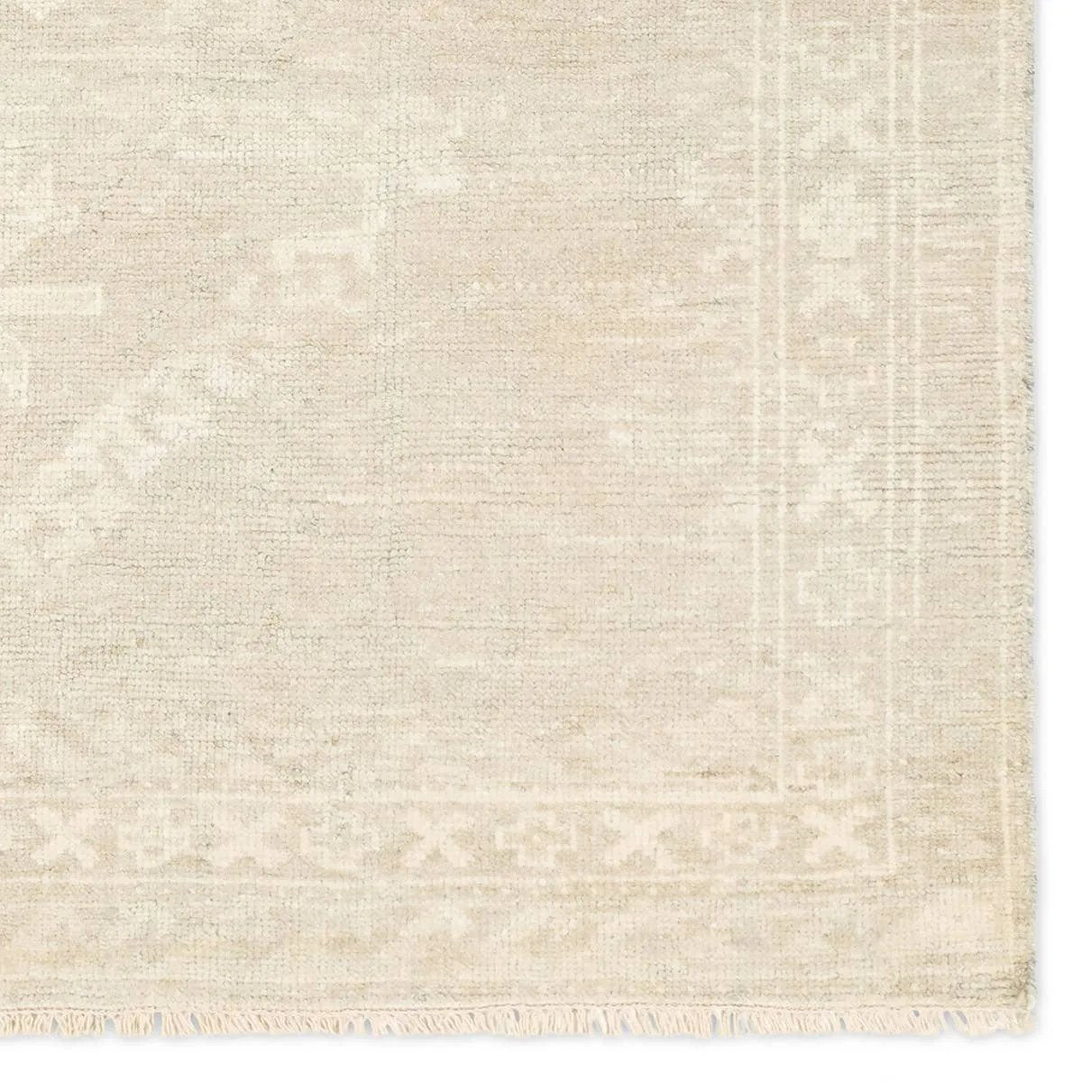 Hand carded wool, soft Tencel, and a neutral color palette define the handknotted Ashend Vavite. The Vavite rug showcases a Moroccan-inspired center medallion in a neutral cream and tan colorway. Geometric detailing establishes a thin border and provides a nod to the tribal styles of northern Africa. Amethyst Home provides interior design, new home construction design consulting, vintage area rugs, and lighting in the Los Angeles metro area.