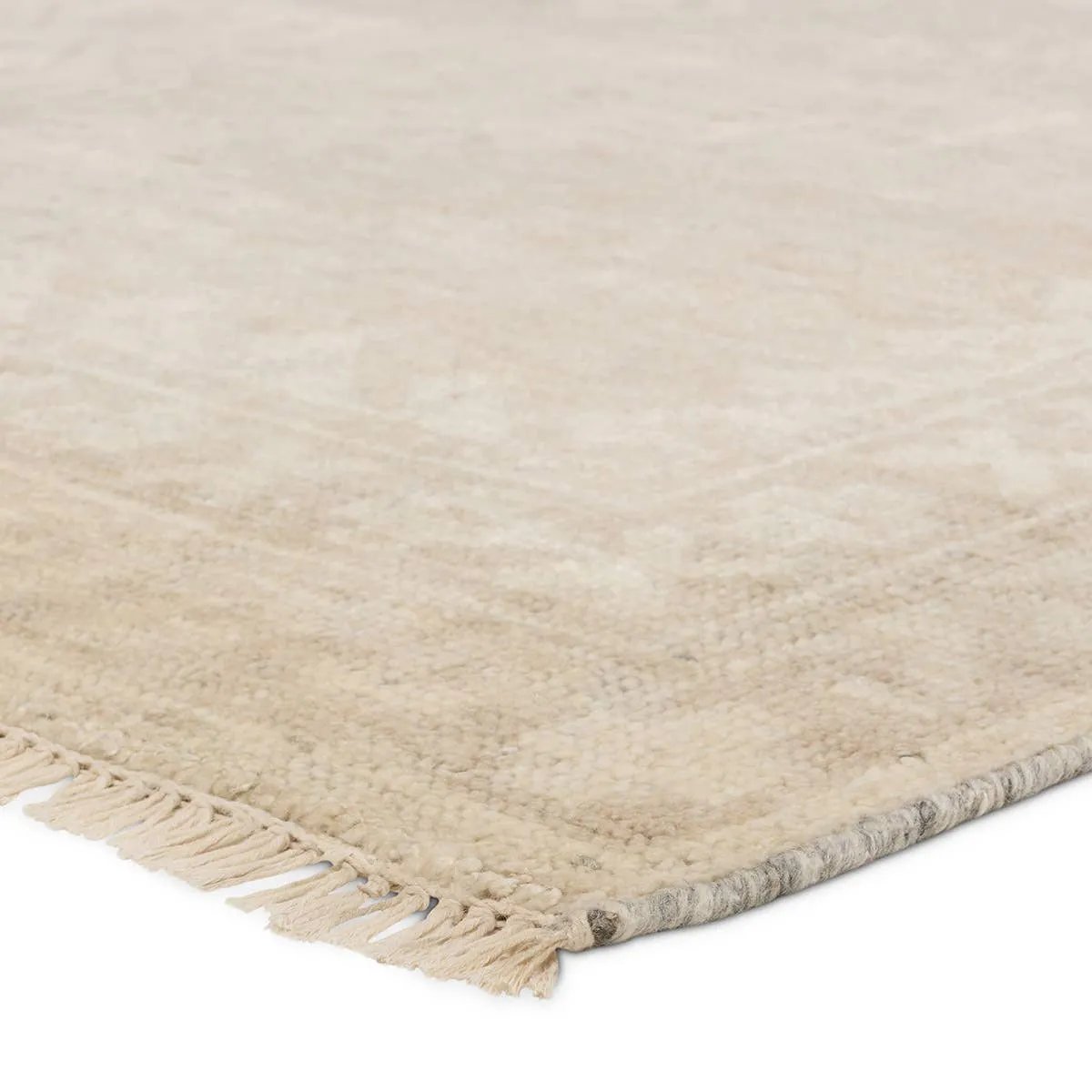 Hand carded wool, soft Tencel, and a neutral color palette define the handknotted Ashend Vavite. The Vavite rug showcases a Moroccan-inspired center medallion in a neutral cream and tan colorway. Geometric detailing establishes a thin border and provides a nod to the tribal styles of northern Africa. Amethyst Home provides interior design, new home construction design consulting, vintage area rugs, and lighting in the San Diego metro area.