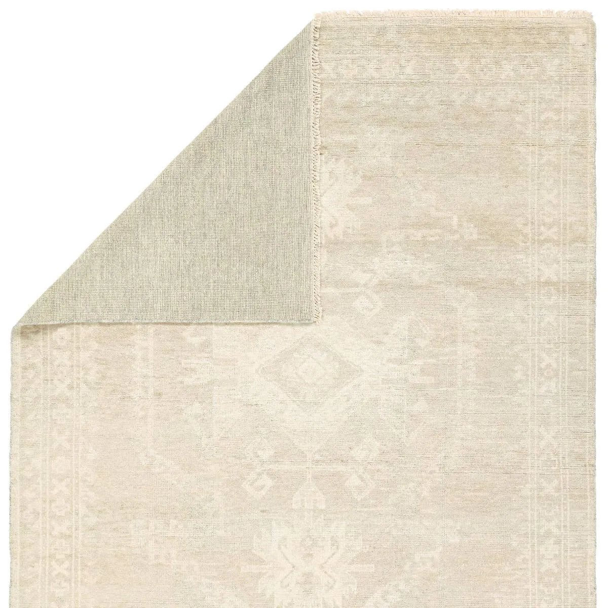 Hand carded wool, soft Tencel, and a neutral color palette define the handknotted Ashend Vavite. The Vavite rug showcases a Moroccan-inspired center medallion in a neutral cream and tan colorway. Geometric detailing establishes a thin border and provides a nod to the tribal styles of northern Africa. Amethyst Home provides interior design, new home construction design consulting, vintage area rugs, and lighting in the Winter Garden metro area.